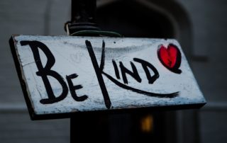 Sign that says "Be Kind" with a red heart